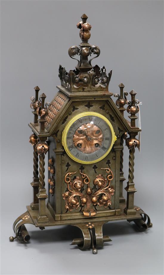 A late 19th century French wrought iron and copper mounted eight mantel clock height 47.5cm